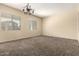 Bright living room features neutral walls, plush carpet, and natural light from two windows at 4335 E Sleighbell Dr, Gilbert, AZ 85297