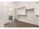 Organized walk-in closet with built-in shelves, carpet and access to the bathroom at 4335 E Sleighbell Dr, Gilbert, AZ 85297