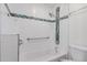 Bright bathroom featuring a tub with a modern tile surround and a convenient grab bar at 4401 E Hubbell St # 57, Phoenix, AZ 85008