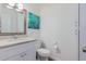 Well-appointed half bathroom with a stylish mirror and updated fixtures and toilet at 4401 E Hubbell St # 57, Phoenix, AZ 85008
