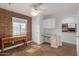 Versatile room with brick accent wall, desk, and built-in storage, ideal as an office or guest room at 4401 E Hubbell St # 57, Phoenix, AZ 85008