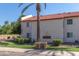 Apartment complex with 2 stories and a sign that reads 'The Palms' on a sunny day at 4401 E Hubbell St # 57, Phoenix, AZ 85008