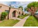 Inviting brick exterior with a charming arched entryway and a lush green lawn at 4401 E Hubbell St # 57, Phoenix, AZ 85008