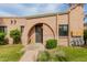 Charming brick home featuring a unique arched entryway and well-maintained front yard at 4401 E Hubbell St # 57, Phoenix, AZ 85008