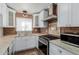Modern kitchen with white cabinets, stainless steel appliances, granite counters, and a striking brick backsplash at 4401 E Hubbell St # 57, Phoenix, AZ 85008