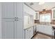 Well-lit kitchen featuring white cabinets, granite countertops, brick accent wall and stainless steel appliances at 4401 E Hubbell St # 57, Phoenix, AZ 85008