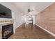 Spacious living room with a cozy fireplace, tile flooring, and abundant natural light at 4401 E Hubbell St # 57, Phoenix, AZ 85008