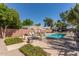 Community swimming pool surrounded by lush greenery, mature trees, and lounge chairs at 4401 E Hubbell St # 57, Phoenix, AZ 85008