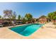 Refreshing community pool with ample deck space, shaded seating, and well-maintained landscaping at 4401 E Hubbell St # 57, Phoenix, AZ 85008