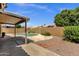 Relaxing backyard with refreshing pool, covered patio, desert landscaping, and privacy fence at 4434 E Thistle Landing Dr, Phoenix, AZ 85044