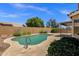 Backyard features a refreshing pool, desert landscaping and privacy fence for a relaxing outdoor space at 4434 E Thistle Landing Dr, Phoenix, AZ 85044