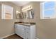 Bathroom featuring double sinks, ample lighting, and tiled floors offering practicality and elegance at 4434 E Thistle Landing Dr, Phoenix, AZ 85044