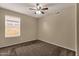 Comfortable carpeted bedroom with a window and ceiling fan, offering a serene living space at 4434 E Thistle Landing Dr, Phoenix, AZ 85044