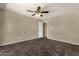 Carpeted bedroom with ceiling fan providing comfort and an inviting atmosphere at 4434 E Thistle Landing Dr, Phoenix, AZ 85044