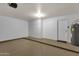 Spacious two car garage with epoxy floor, built in storage cabinets, and water heater at 4434 E Thistle Landing Dr, Phoenix, AZ 85044