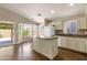 Well-lit kitchen with a granite island, recessed lights, and modern appliances at 4434 E Thistle Landing Dr, Phoenix, AZ 85044
