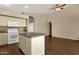 Open kitchen with island, appliances, and tile backsplash at 4434 E Thistle Landing Dr, Phoenix, AZ 85044