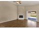 Spacious living room showcasing a fireplace and sliding glass doors leading to a pool at 4434 E Thistle Landing Dr, Phoenix, AZ 85044