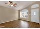 Neutral living room with hardwood floors, a fan and a bright front-facing window at 4434 E Thistle Landing Dr, Phoenix, AZ 85044
