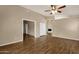 Hardwood floors in a naturally lit living room with views to the dining and fireplace at 4434 E Thistle Landing Dr, Phoenix, AZ 85044