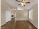 Hardwood floors and vaulted ceilings in a bright living room with open closet doors at 4434 E Thistle Landing Dr, Phoenix, AZ 85044
