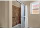 Bathroom shower featuring tile surround, safety bar and sliding glass door at 4434 E Thistle Landing Dr, Phoenix, AZ 85044
