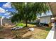 View of the lush backyard, featuring a mature tree and a partial view of the covered patio at 4513 W Yucca St, Glendale, AZ 85304