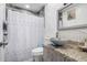 Bathroom featuring a granite countertop vanity and a shower behind a patterned shower curtain at 4513 W Yucca St, Glendale, AZ 85304