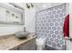 Bathroom featuring vanity with a unique sink bowl, granite countertop, and a shower behind a patterned curtain at 4513 W Yucca St, Glendale, AZ 85304