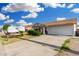 Charming single-story home with a well-maintained front yard, two-car garage, and RV parked on the side at 4513 W Yucca St, Glendale, AZ 85304