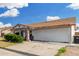 Charming single-story home with a well-maintained front yard, an attached two-car garage, and lush greenery at 4513 W Yucca St, Glendale, AZ 85304