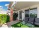 Inviting front porch with cozy seating, artificial grass and charming details, perfect for relaxing outdoors at 4513 W Yucca St, Glendale, AZ 85304