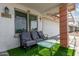 Inviting front porch with comfortable seating, artificial grass, and easy access to the two-car garage at 4513 W Yucca St, Glendale, AZ 85304