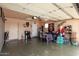 Garage featuring space for a car or a workspace with storage cabinets, coffee maker, mini fridge, and a seating area at 4513 W Yucca St, Glendale, AZ 85304