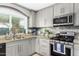 Kitchen with gray cabinets, granite countertops, and stainless steel appliances at 4513 W Yucca St, Glendale, AZ 85304