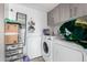 Laundry room featuring washer and dryer, storage cabinets, and shelving for organizing laundry essentials at 4513 W Yucca St, Glendale, AZ 85304