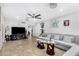 Open living room showcasing a large television and comfortable gray sofa at 4513 W Yucca St, Glendale, AZ 85304