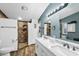 Bright bathroom boasts a double sink vanity and a walk-in shower with stylish tile and a niche for storage at 466 N Rennick Dr, Apache Junction, AZ 85120