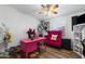 Bedroom features a ceiling fan, wood-look floors, a desk, and a pink armchair at 466 N Rennick Dr, Apache Junction, AZ 85120