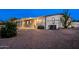 Home exterior features a gravel yard, covered parking, desert landscaping and a cactus at 466 N Rennick Dr, Apache Junction, AZ 85120