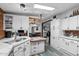Bright kitchen features stainless steel sink, updated cabinets and a dining area at 466 N Rennick Dr, Apache Junction, AZ 85120