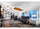 Comfortable living room with skylight, wood floors, neutral decor, and updated lighting at 466 N Rennick Dr, Apache Junction, AZ 85120