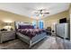 Comfortable main bedroom with a ceiling fan, soft lighting, and wood floors at 466 N Rennick Dr, Apache Junction, AZ 85120