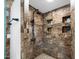Tiled walk-in shower features multiple niches for storage, a modern shower head, and a patterned tile floor at 466 N Rennick Dr, Apache Junction, AZ 85120