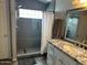 Updated bathroom featuring a sleek walk-in shower and granite countertops at 4721 E Abraham Ln, Phoenix, AZ 85050