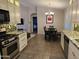 Beautiful kitchen featuring granite countertops, white cabinetry, a dining table and open access to other rooms at 4721 E Abraham Ln, Phoenix, AZ 85050