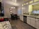 A bright kitchen with white cabinets, granite countertops, and stainless steel appliances, adjacent to a dining area at 4721 E Abraham Ln, Phoenix, AZ 85050
