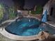 Backyard features a dark, inviting pool with a waterfall, perfect for evening relaxation and entertainment at 4721 E Abraham Ln, Phoenix, AZ 85050