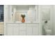 Well-lit bathroom with double sinks, white cabinetry, and modern fixtures at 4748 E Amethyst Ln, San Tan Valley, AZ 85143