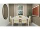 Bright dining room with modern table, stylish chairs, neutral colors, and decorative wall accents at 4748 E Amethyst Ln, San Tan Valley, AZ 85143
